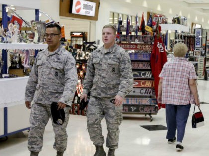 In this May 24, 2017, photo, members of the military and civilians with shopping privileges walk among stores at the Exchange, at Offutt Air Force Base, Neb. Starting in fall 2017, all honorably discharged veterans will be eligible to shop tax-free online at the Exchange with the same discounts they …