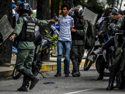 Members of the National Guard arrest an opposition activists during clashes following a ma