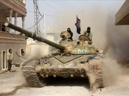 Fighters from a coalition of Islamist forces arrive to the town of Ariha on May 28, 2015 i