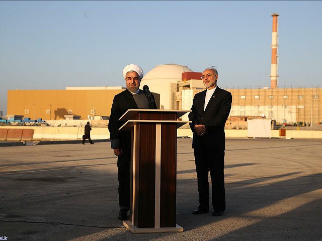 In this photo released by the Iranian Presidency Office, President Hassan Rouhani, left, s