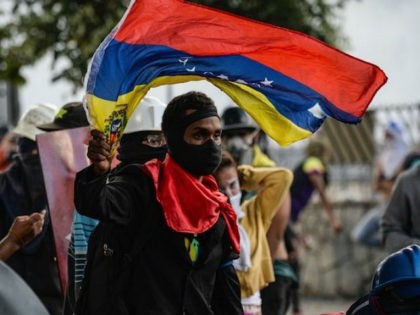 Opposition demonstrators protest in Caracas, on July 26, 2017. Venezuelans blocked off des