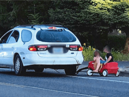 An Oregon mother is accused of using her car to pull three children seated in a plastic wagon.