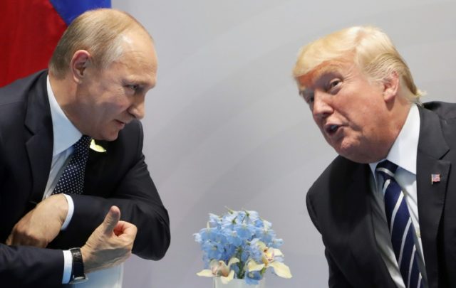 US President Donald Trump (right) and Russia's President Vladimir Putin speak on the sidel