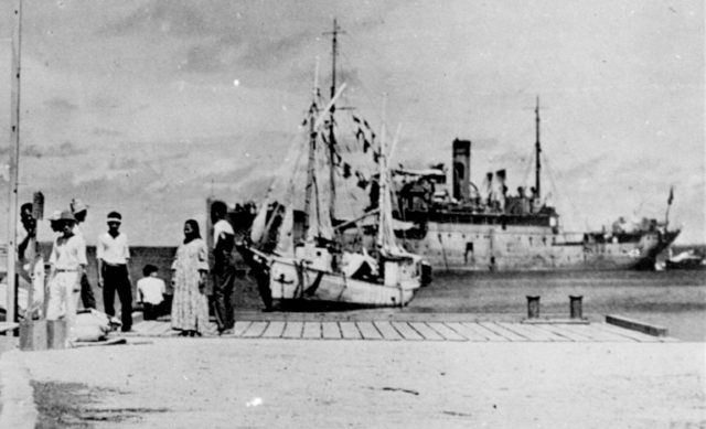 A group of people standing on a dock in the 1930's, one that some thought was Amelia Ear