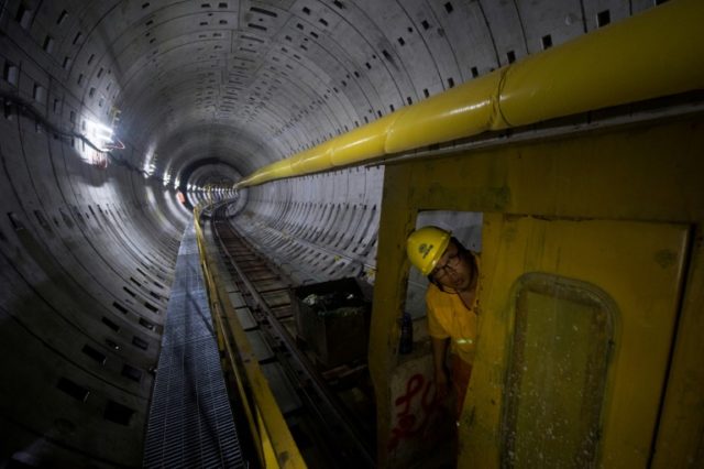 A worker looks out of a train at the construction site of Line 14 of the Shanghai metro sy