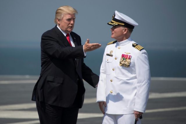 US President Donald Trump (L) is welcomed by USS Gerald R. Ford's Captain Rick McCormack (