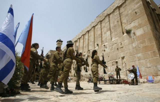 Israeli soldiers stand outside Hebron's Tomb of the Patriarchs, also known as the Ibr