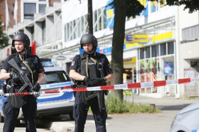 Police cordon off the area around a supermarket in the northern German city of Hamburg, wh