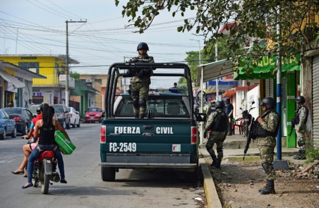 Mexican police patrol in Veracruz State, where scores of Central Americans being smuggled