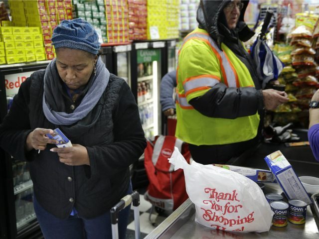 woman-buying-food-with-food-stamps-ebt-card-AP-640x480