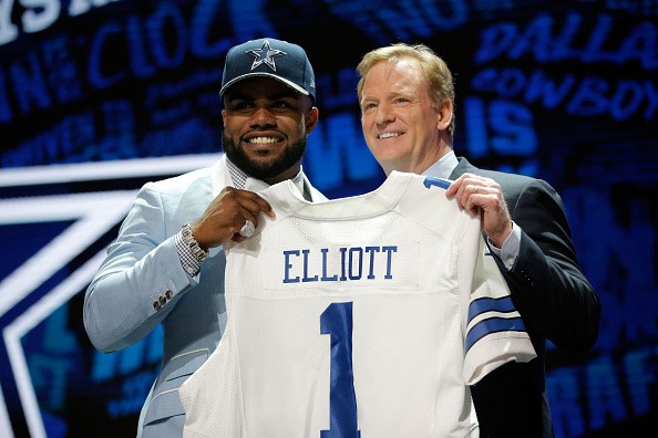 CHICAGO, IL - APRIL 28: (L-R) Ezekiel Elliott of Ohio State holds up a jersey with NFL Co