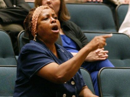 Sandra Crenshaw, center, interupts a Dallas City Council meeting, Wednesday, Aug. 27, 2003, to protest the firing of Police Chief Terrell Bolton. He was dismissed Tuesday by city manager Ted Benavides, who didn't offer a specific reason. (AP Photo/Donna McWilliam)