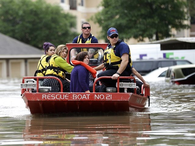 Residents are evacuated from their flooded apartment complex Tuesday, April 19, 2016, in H