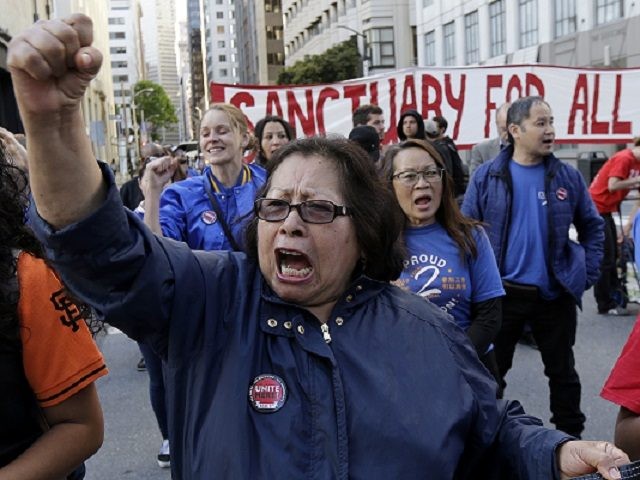 Guadalupe Chavez, center, and others yell during a protest outside of the U.S. Citizen and