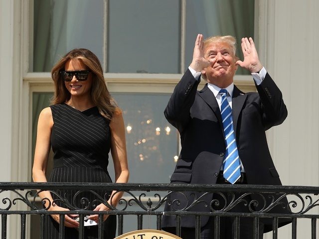 President Donald Trump, accompanied by first lady Melania Trump, gestures at the White House in Washington, Monday, Aug. 21, 2017, as they viewed the solar eclipse. (AP Andrew Harnik)
