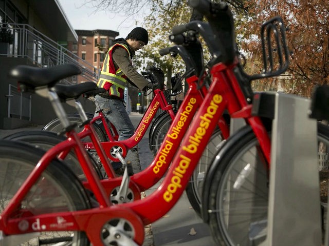 Diego Jaramillo adds a Capital Bikeshare bicycle to a docking station in Washington, D.C.,