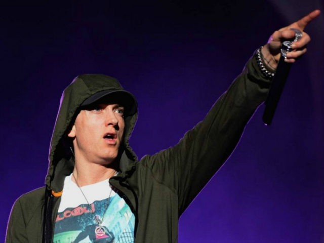 Rapper Eminem pointing on stage.