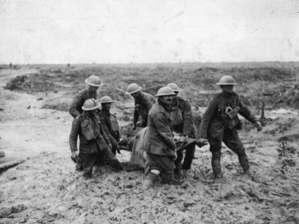 A stretcher-bearing party carrying a wounded soldier through the mud near Boesinghe during