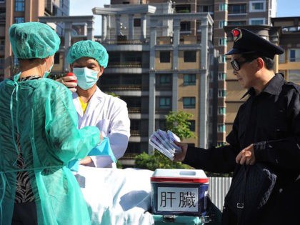 Members of the spiritual movement Falungong act out a scene of stealing human organs to se