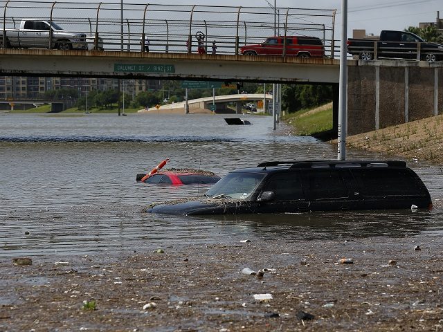 Vehicles are left stranded on Texas State Highway 288 in Houston, Texas on May 26, 2015.