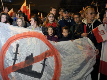 Right-wing nationalist protesters hold a banner with crossed out mosque during the annual march that coincides with Poland's National Independence Day in Wroclaw on November 11, 2015. Poland's National Independence Day commemorates the anniversary of the Restoration of a Polish State in 1918. PHOTO / NATALIA DOBRYSZYCKA (Photo credit should …
