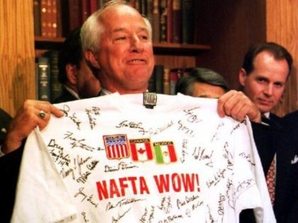 WASHINGTON, DC - NOVEMBER 17: During a Capitol Hill news conference late 17 November 1993 with supporters of the North American Free Trade Agreement, U.S. Representative Jim Kolbe, R-Arizona, holds up a t-shirt signed by other members of the House of Representatives bearing the slogan "NAFTA Wow!" after the House …