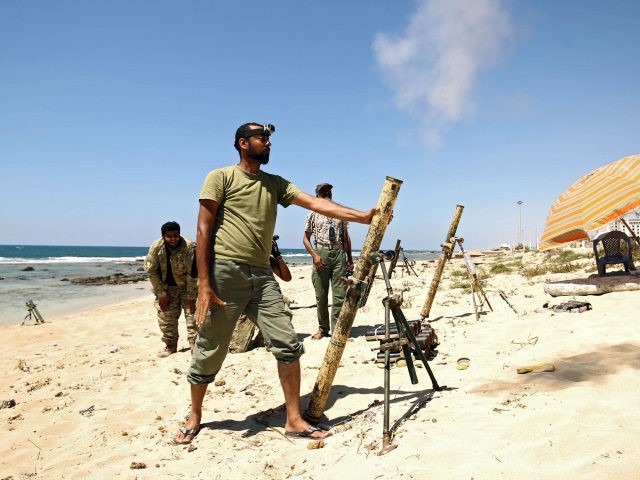 TOPSHOT - Members of the self-styled Libyan National Army, loyal to the country's east strongman Khalifa Haftar, fire mortar shells during clashes with militants in Benghazi's central Akhribish district on July 19, 2017. Libyan military strongman Khalifa Haftar on July 5, 2017, announced the 'total liberation' of second city Benghazi, …