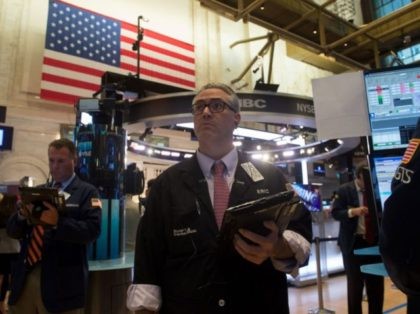A trader works on the floor at the closing bell of the Dow Industrial Average at the New York Stock Exchange on August 8, 2017 in New York. Wall Street stocks fell Tuesday amid rising tensions between the US and North Korea, bringing the Dow's streak of nine straight records …