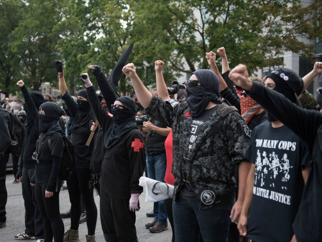 Counter-protesters clash with police in Quebec City, Canada, on August 21, 2017. Clashes erupted Sunday between police and dozens of anti-racist activists on the sidelines of a pro-immigration rally in Quebec City while a demonstration organized by extreme-right activists gained little traction. In a bid to keep the two rallies …