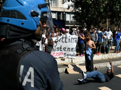 Refugees and asylum seekers react after being displaced from a palace in the center of Rom