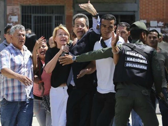 Venezuelan General Prosecutor Luisa Ortega Diaz, third left, is surrounded by loyal employ