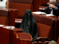 One Nation Senator Pauline Hanson wears a burqa during question time in the Senate chamber at Parliament House in Canberra, Australia, Thursday, Aug. 17, 2017.