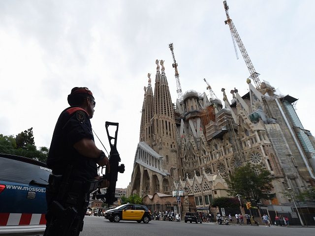 Police officers stand guard in front of the "Sagrada Familia" (Holy Family) basilica in Barcelona on August 19, 2017, two days after a van ploughed into the crowd, killing 13 persons and injuring over 100. Drivers have ploughed on August 17, 2017 into pedestrians in two quick-succession, separate attacks in …