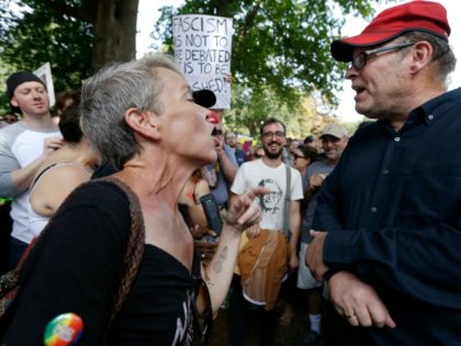Protesters with opposing views face off at a "Free Speech" rally organized by co