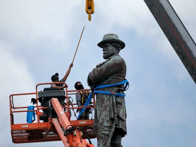 FILE- In this May 19, 2017, file photo, workers prepare to take down the statue of former