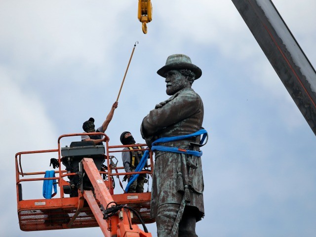 FILE- In this May 19, 2017, file photo, workers prepare to take down the statue of former Confederate general Robert E. Lee, which stands over 100 feet tall, in Lee Circle in New Orleans. Hanceville Mayor Kenneth Nail wrote to New Orleans Mayor Mitch Landrieu, asking him and city leaders to consider donating Confederate monuments recently removed from their pedestals in New Orleans to his town so they could be displayed in Veterans Memorial Park in Hanceville, Ala. Landrieu's office didn't immediately respond Monday, June 19, to an emailed request for comment. (AP Photo/Gerald Herbert, File)