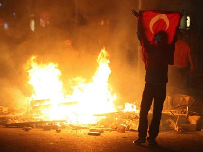A protestor holds a national flag of Turkey during a demonstration in Ankara, early on Jun