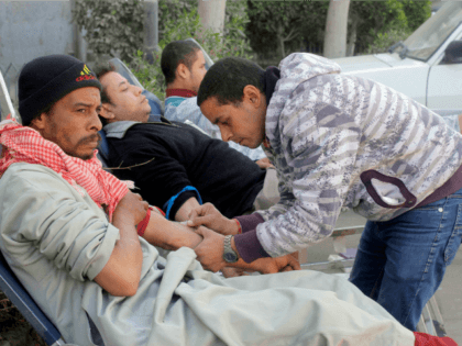 Egyptians donate their blood at a hospital following a train crash in Badrasheen, 40 KM So