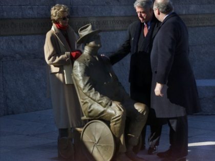 President Clinton views the new statue of Franklin Delano Roosevelt with two of Roosevelt's grandchildren Ann Roosevelt, left and Jim Roosevelt, right, at the dedication ceremony for the new prologue to the FDR Memorial in Washington, Thursday, January 10, 2001. The new statue depicts the disable president in his wheelchair. …