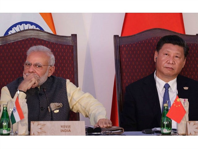 Indian Prime Minister Narendra Modi, left, and Chinese President Xi Jinping listen to a speech during the BRICS Leaders Meeting with the BRICS Business Council in Goa, India, Sunday, Oct. 16, 2016. Brazil, Russia, India, China and South Africa, or BRICS, face the tough task of asserting their growing influence …