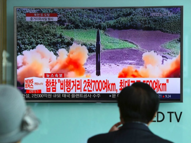 People watch a television news screen showing file footage of a North Korean missile launch, at a railway station in Seoul on August 29, 2017. Nuclear-armed North Korea fired a ballistic missile over Japan and into the Pacific Ocean on August 29 amid tensions over its weapons ambitions