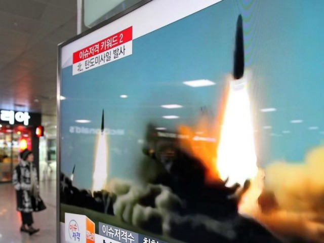 FILE - In this March 10, 2016, file photo, a TV screen shows a file footage of the missile