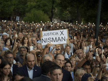 People hold candles during a vigil on the first anniversary of Argentinian prosecutor Albe