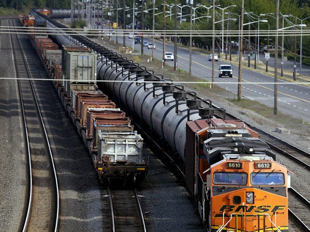 FILE - In this July 27, 2015, file photo, traffic passes one of two mile-long oil trains p