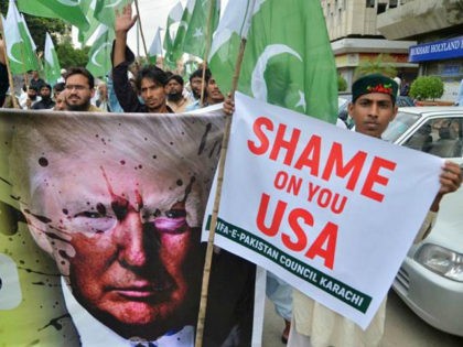 Supporters of Defence of Pakistan Council, a coalition of around 40 religious and political parties, carry banners during a protest against US President Donald Trump in Karachi on August 25, 2017. Angry and offended Pakistanis fired back against Donald Trump's accusations that their country harbours militants, highlighting the heavy toll …