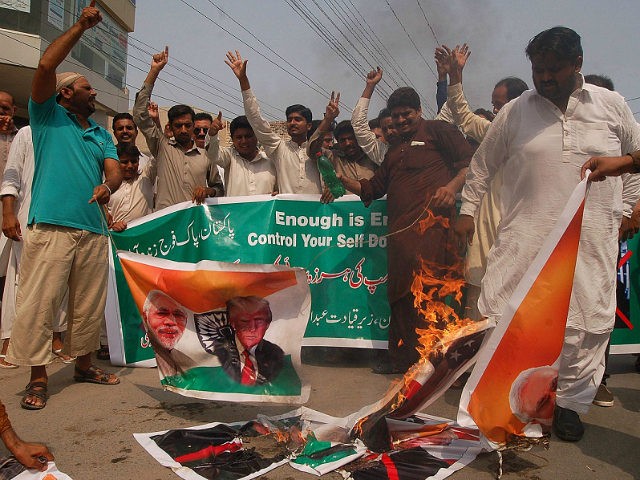Pakistani protesters burn pictures of U.S. President Donald Trump and Indian Prime Ministe