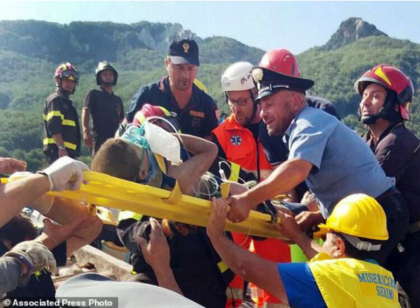 Firefighters and rescuers pull out a boy, Mattias, from the collapsed building in Casamicciola, on the island of Ischia, near Naples, Italy, a day after a 4.0-magnitude quake hit the Italian resort island, Tuesday, Aug. 22, 2017. irefighters freed a 7-month-old baby and an older brother from rubble of a …