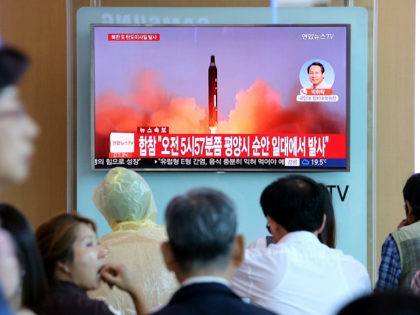 People watch a TV screen showing a file footage of North Korea's missile launch, at the Se