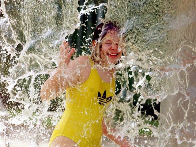 Twelve-year-old Jennifer (no surmane available) takes a shower at the open air municipal s