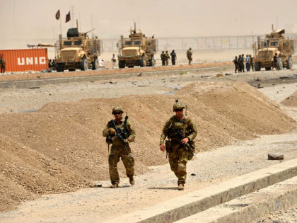 US soldiers walk at the site of a Taliban suicide attack in Kandahar on August 2, 2017. A